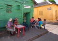 Locals and tourists eating in Local restaurants and street cafes on the scenic colorful streets of Cartagena in historic Getsemani