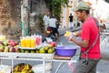 A fruit vendor cutting mango in Cartagena.