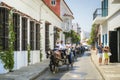 Cartagena, Colombia - March 26 2017: Horse drawn carriage driver waving while traveling down a Cartagena street