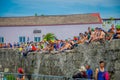 CARTAGENA, COLOMBIA - NOVEMBER 07, 2019: Unidentified spectators sitting in a wall at the independence day parade on the