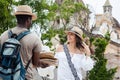 Beautiful young woman buying a traditional Colombian hat from an street vendor in