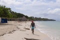 Cartagena de Indias, Colombia-Nov 21, 2010: A woman walks deep in thoughts of her on the beach of Isla Baru, next to the sea, in