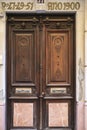 Old wooden and marble door with beautiful iron door handles