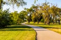 Paved trail along the shores of Carter Lake Iowa with visible dead trees along the path