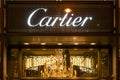 Cartier, illuminated jewelry brand name on Champs Elysees avenue in Paris