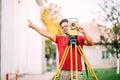 Cartographer engineer, surveyor working with total station construction site elevation Royalty Free Stock Photo