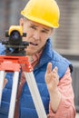 Cartographer Gesturing While Using Theodolite Royalty Free Stock Photo