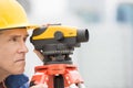 Cartographer Measuring Distances Through Theodolite