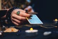 Cartomancy. The fortune teller holds Tarot card. Close up. The concept of divination, astrology and esotericism Royalty Free Stock Photo