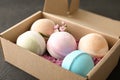 Carton box with bath bombs on black table Royalty Free Stock Photo