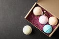 Carton box with bath bombs and space for text on black background