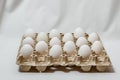 Carton box with distanced white eggs on white background. concept of quarantine rules Royalty Free Stock Photo