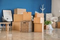 Carton boxes and interior items on floor in room. Moving house concept Royalty Free Stock Photo