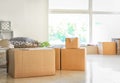 Carton boxes and interior items on floor in room. Moving house concept Royalty Free Stock Photo