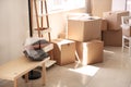 Carton boxes and interior items on floor in room. Moving house concept Royalty Free Stock Photo