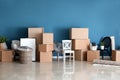 Carton boxes and interior items on floor in room. Moving house concept Royalty Free Stock Photo