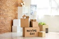 Carton boxes and interior items in room. Moving house concept Royalty Free Stock Photo