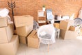 Carton boxes and interior items in room. Moving house concept Royalty Free Stock Photo