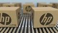Carton boxes with HP logo move on roller conveyor. Realistic 3D rendering