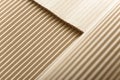 Carton or cardboard packing material. Texture of corrugated paper sheets made from cellulose. Supplies for creating boxes. Royalty Free Stock Photo