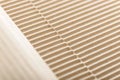 Carton or cardboard packing material. Texture of corrugated paper sheets made from cellulose. Supplies for creating boxes. Royalty Free Stock Photo