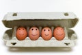 Carton of eggs with kids drawings of face of family in black pen with happy expressions Royalty Free Stock Photo