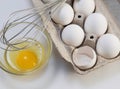 Carton of eggs with whisk Royalty Free Stock Photo