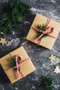 Carton gift boxes decorated twine, candy cane, fir branches on stone table. Flat lay, top view. Christmas gift, New Year present Royalty Free Stock Photo