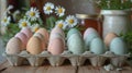 A carton of pastel-colored easter eggs with daisies Royalty Free Stock Photo