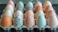 A carton of pastel-colored speckled eggs. Royalty Free Stock Photo