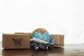 Cartons with airplane and earth globe. Online shopping, International delivery and global logistics concept Royalty Free Stock Photo