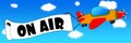 Cartoon aeroplane and banner with ON AIR text on a blue sky back