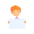 Cartoon boy holding empty poster isolated on white. Kid character with red hair and happy face expression. Sign with Royalty Free Stock Photo
