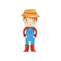 Cartoon character of young farmer in blue overall, red sweater, boots and straw hat. Little gardener. Smiling boy with