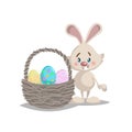 Cartoon cute smiling easter bunny with big basket and painted colorful eggs. Spring character mascot and seasonal vector illustrat
