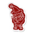 cartoon distressed sticker of a bearded man wearing santa hat