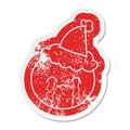 cartoon distressed sticker of a orange wearing santa hat