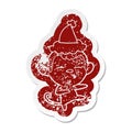 cartoon distressed sticker of a suspicious monkey wearing santa hat