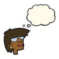 cartoon female face with glasses with thought bubble