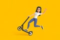 Cartoon funny cute girl in a white T-shirt and jeans rides electric scooter, makes extreme tricks on a yellow background