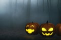 Cartoon funny smile pumpkin with glowing face in foggy forest 3d illustrations