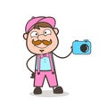 Cartoon Happy Adult Salesman Showing a Camera for Advertisement