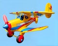 Cartoon happy comic child toy airplane biplane flying single prop yellow Royalty Free Stock Photo