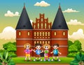 Cartoon of Happy school children standing in front of Holstentor building