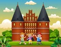 Cartoon of Happy school children standing in front of Holstentor building