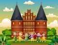 Cartoon of Happy school children standing in front of Holstentor building Royalty Free Stock Photo