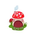 Cartoon hobbit house in form of mushroom with red spotted roof. Fantasy home with wooden door and tiny windows. Flat Royalty Free Stock Photo