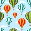 Cartoon hot air balloons in blue sky seamless pattern for air travel concept. Illustration of striped air balloon pattern f