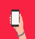 Cartoon human hand in handcuffs hold smartphone with white empty screen isolated on red