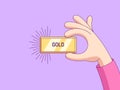 Cartoon human hand keeps and shows gold bar. Golden ingot with rays, bank reserve